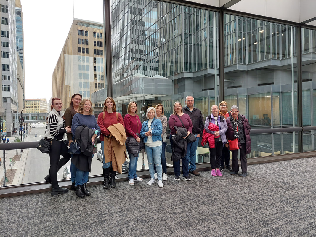 large group of people standing in a minneapolis skyway 